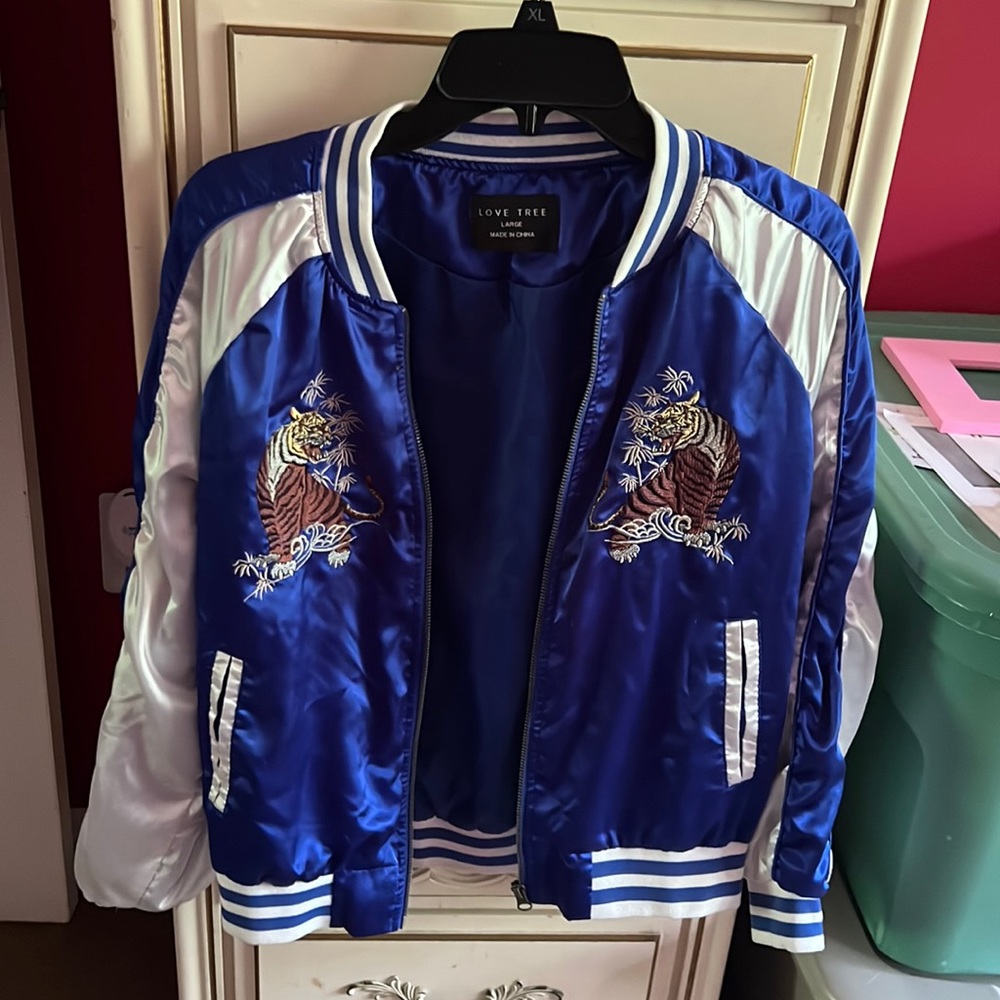 Dark blue and white zip jacket with tigers on it.  Extra small / small